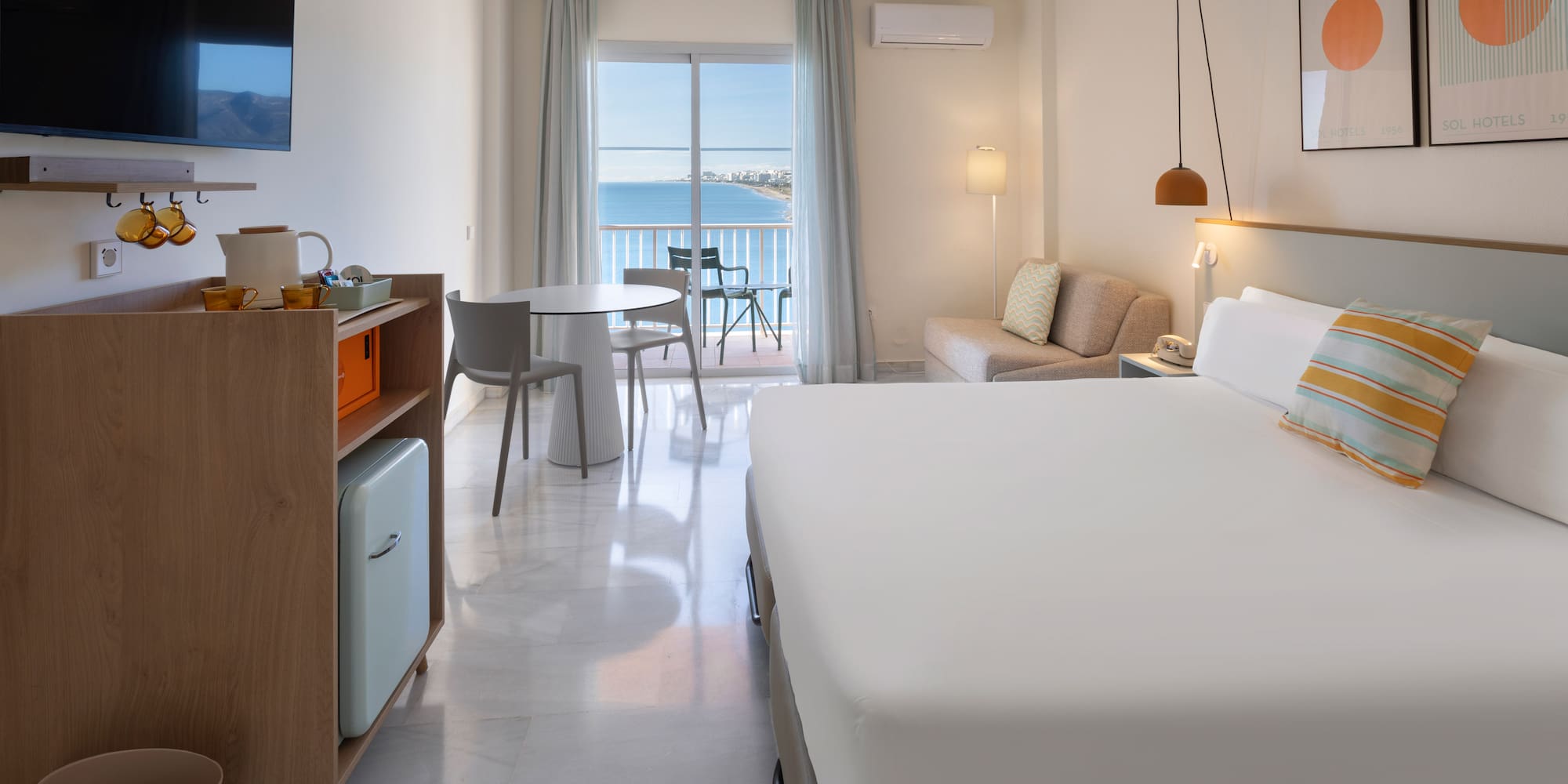 a room with a bed and a table and chairs