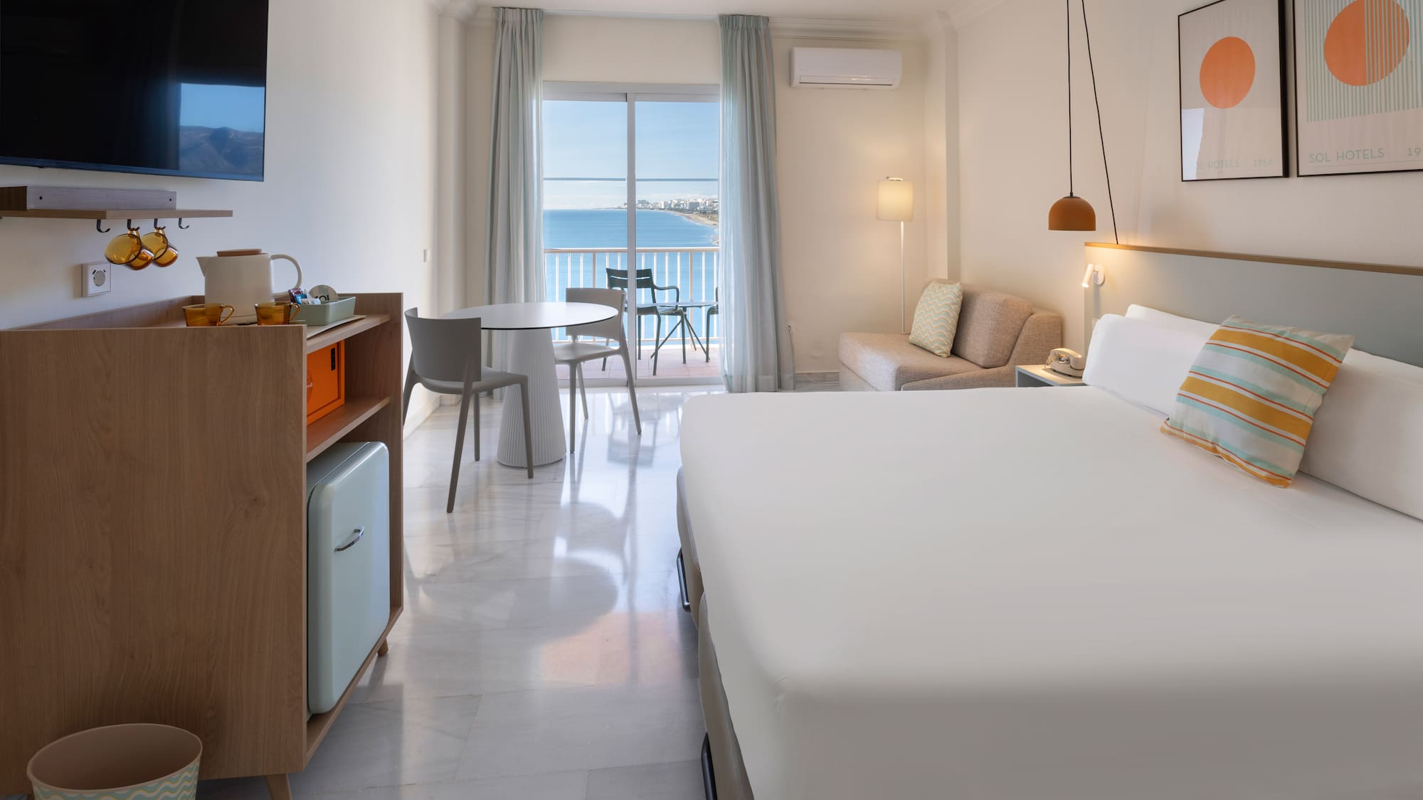 a room with a bed and a table and chairs