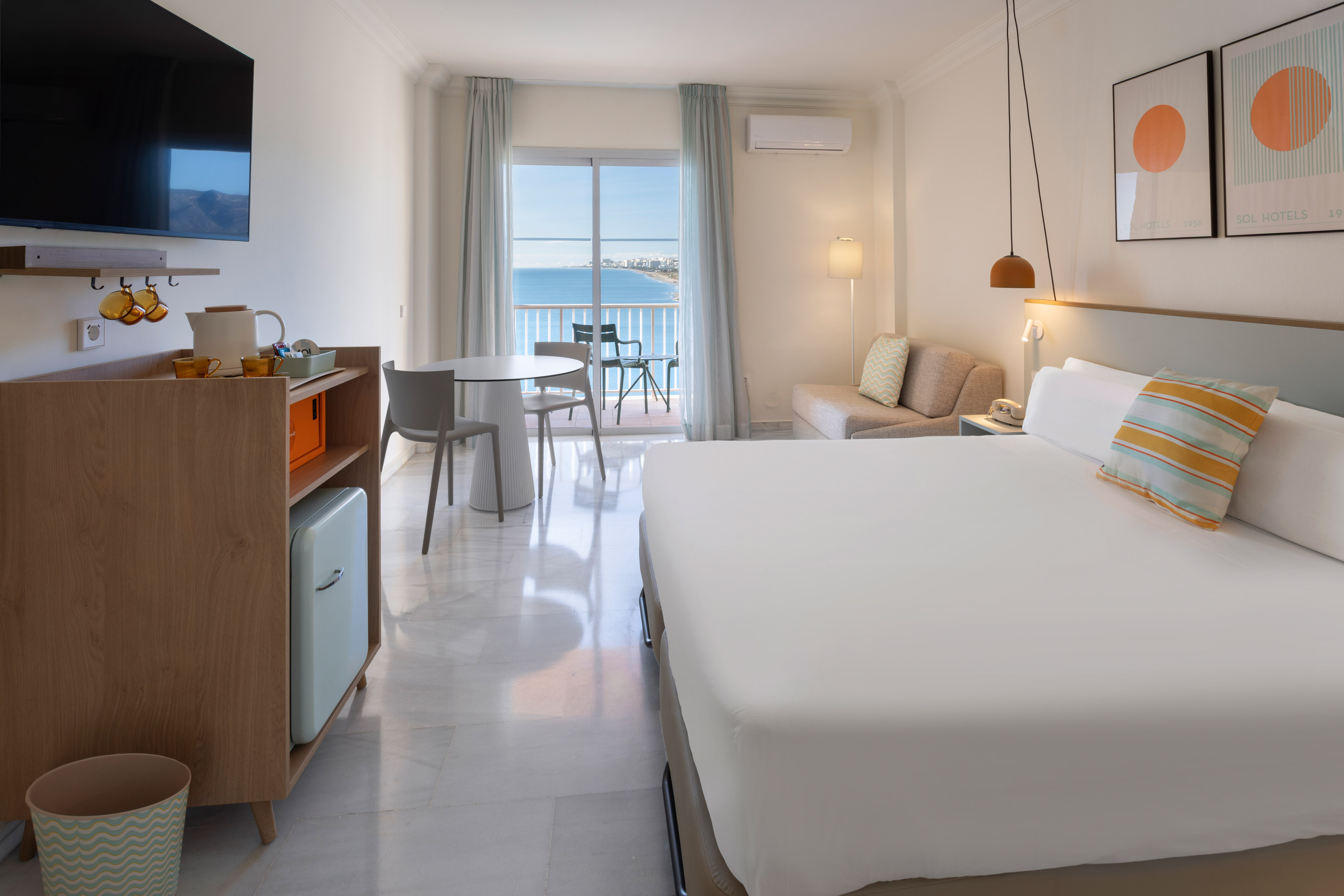 a room with a bed and a table and chairs