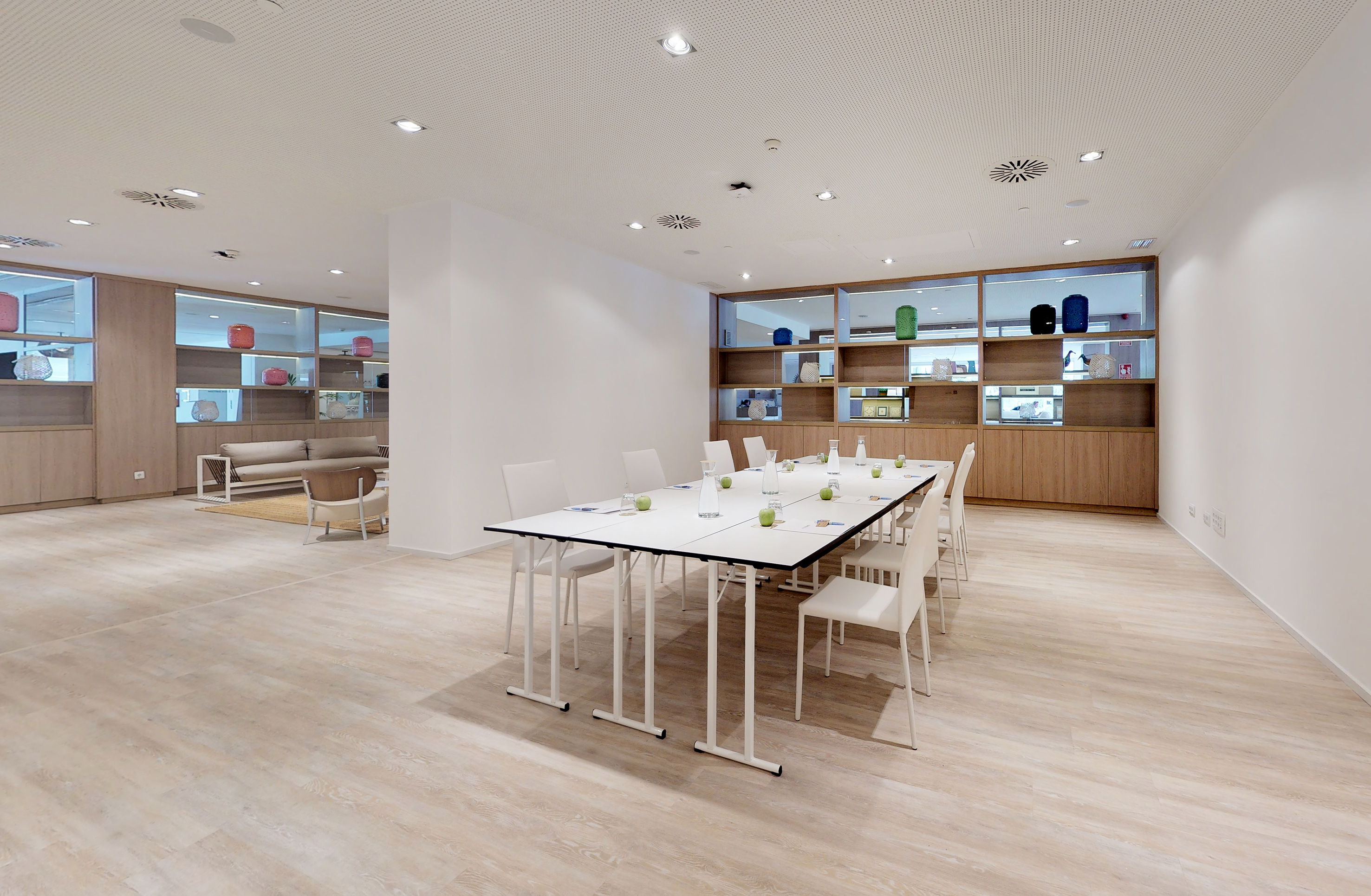 Bright, modern meeting & conference room with large table and lounge area.