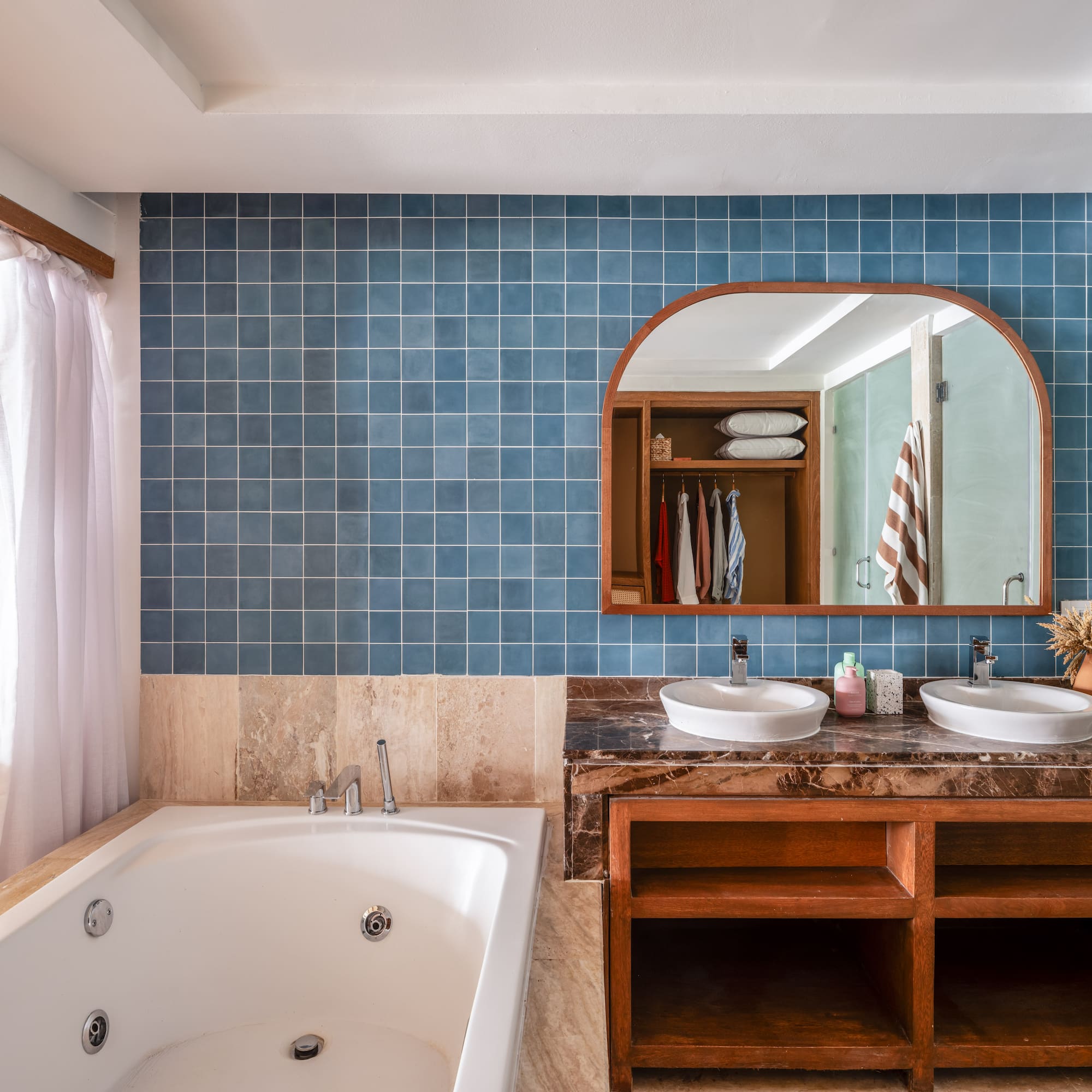 a bathroom with a bathtub and a mirror