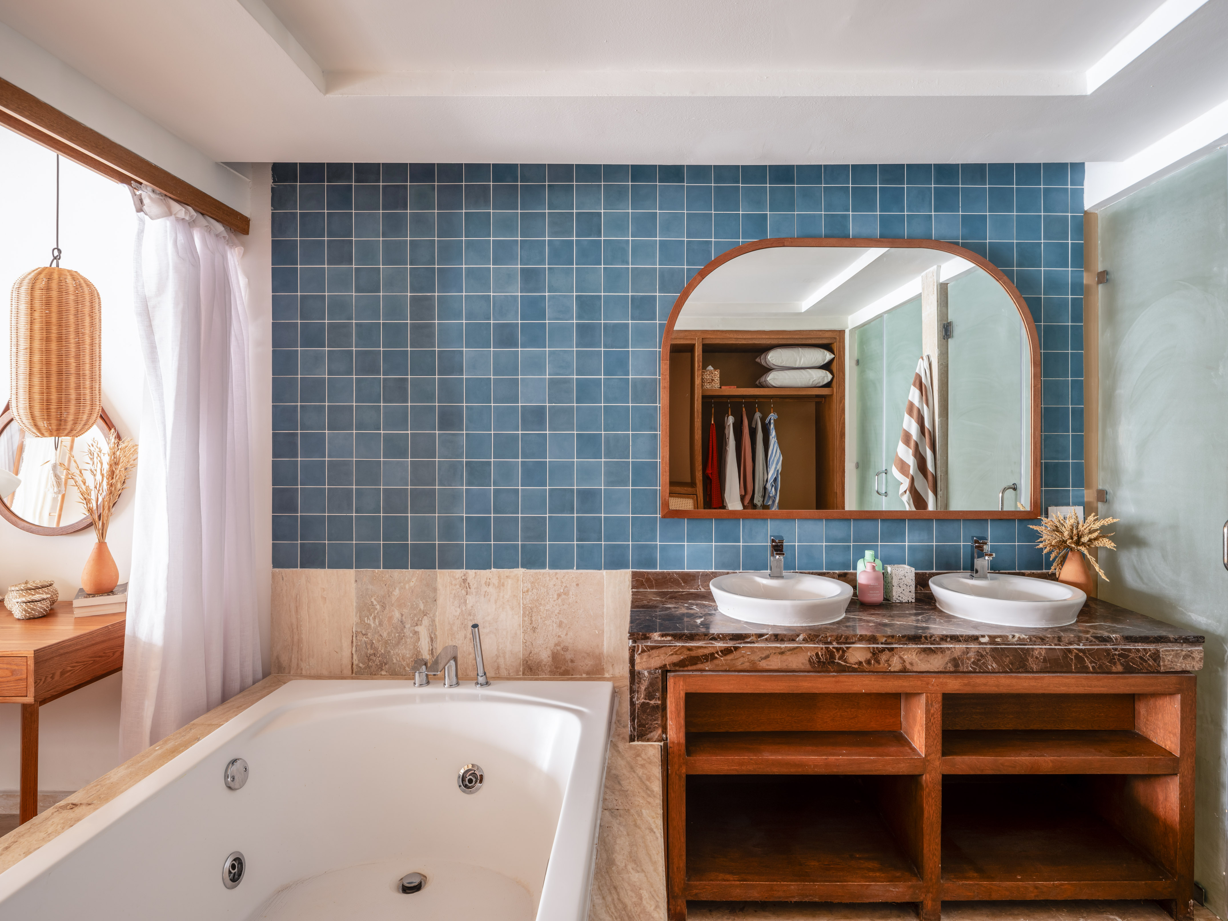a bathroom with a bathtub and a mirror
