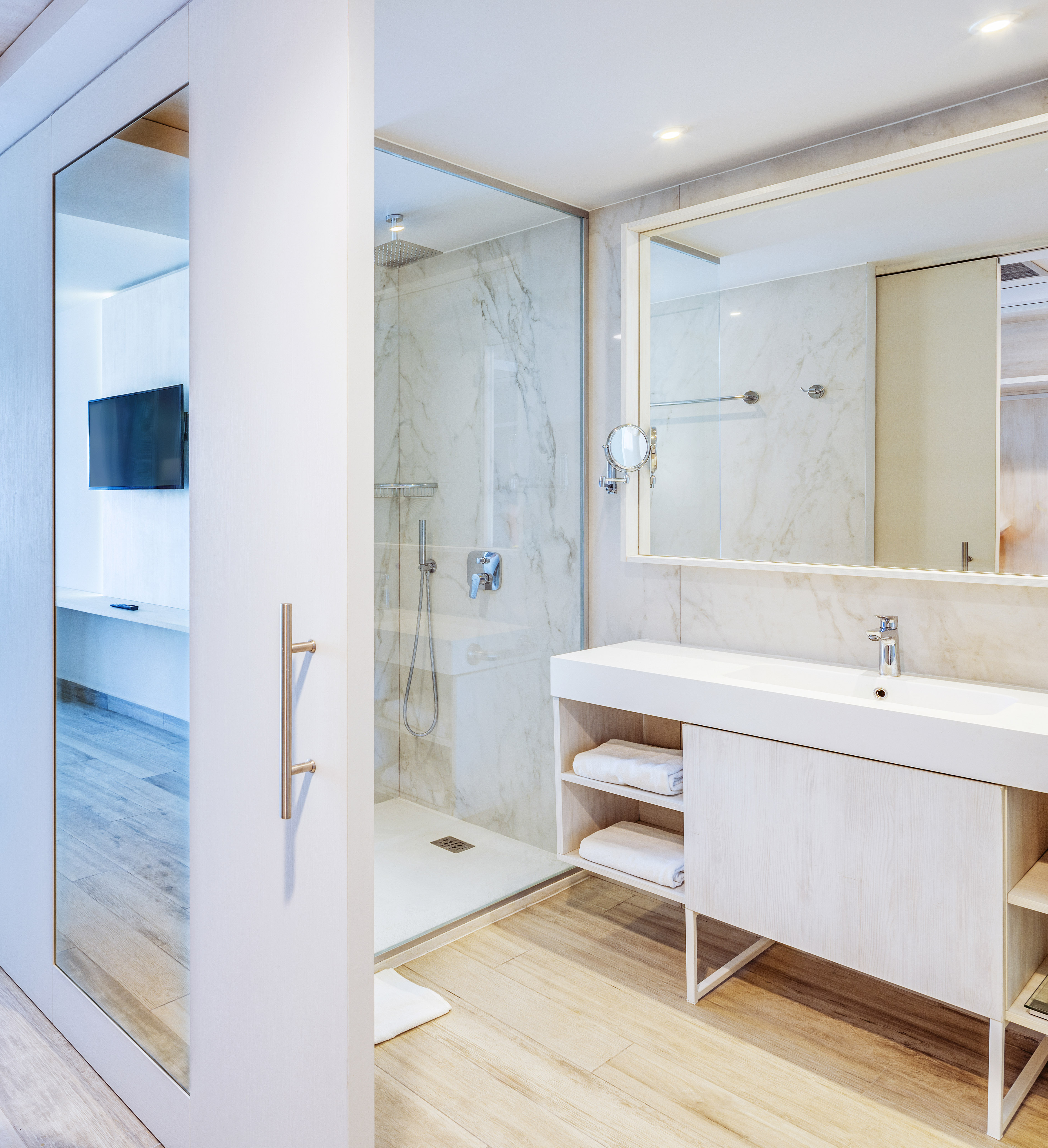 a bathroom with a shower and a mirror
