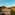 Andalusian white village nestled in sunlit mountains at golden hour.