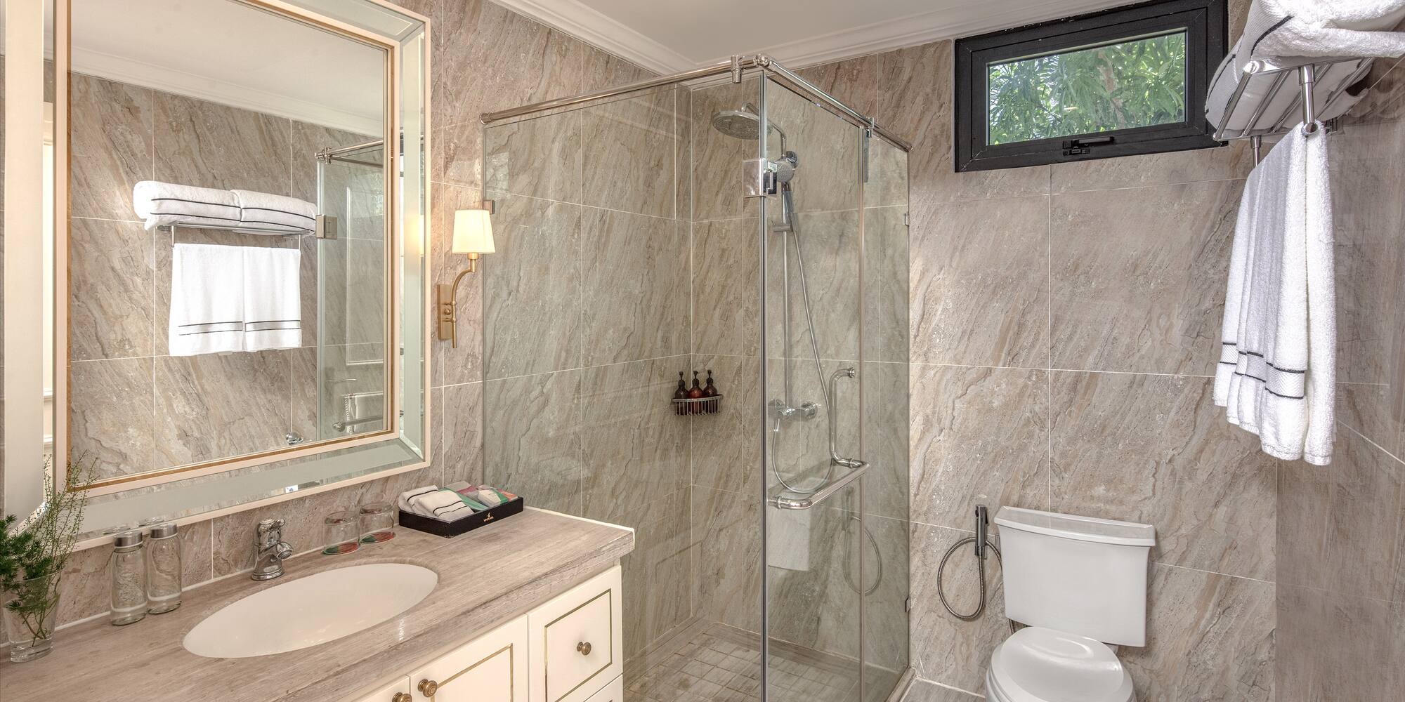 a bathroom with a glass shower and sink