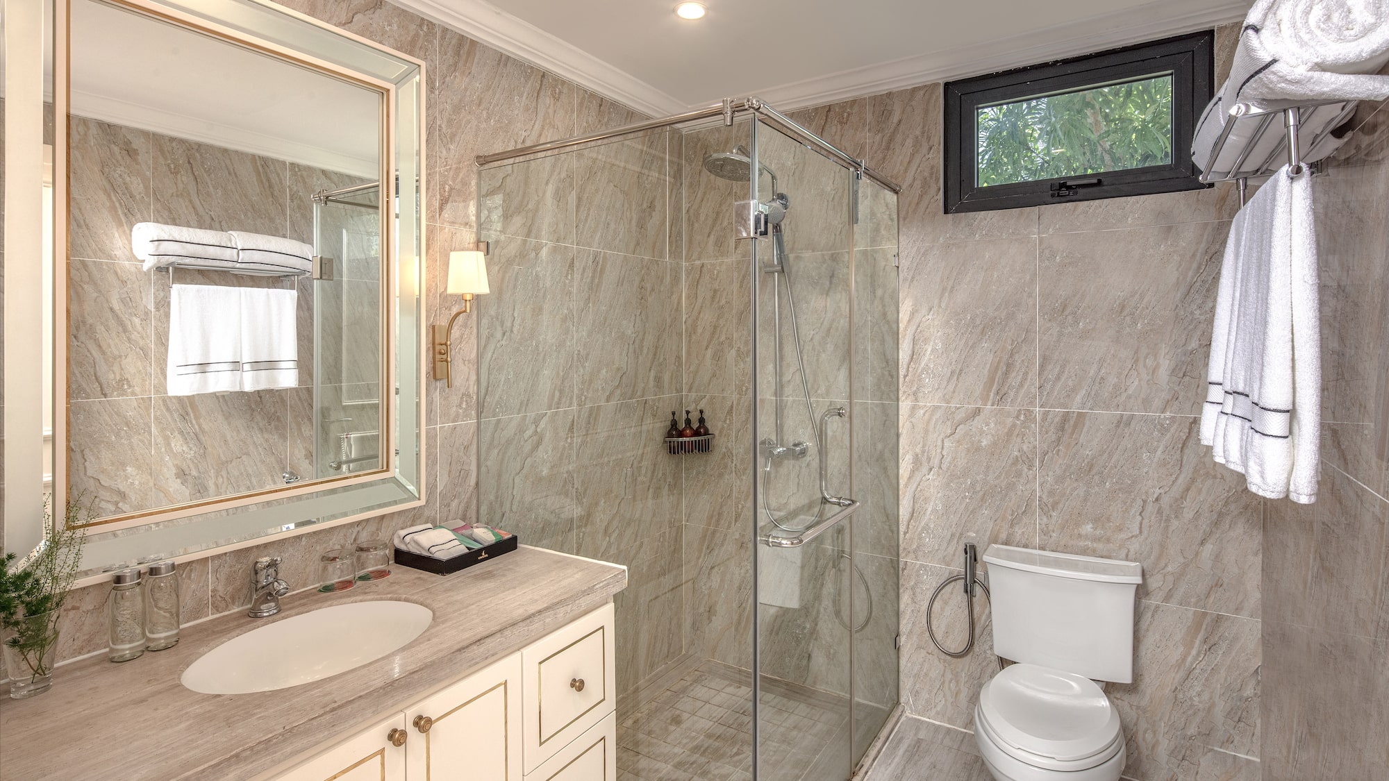 a bathroom with a glass shower and sink