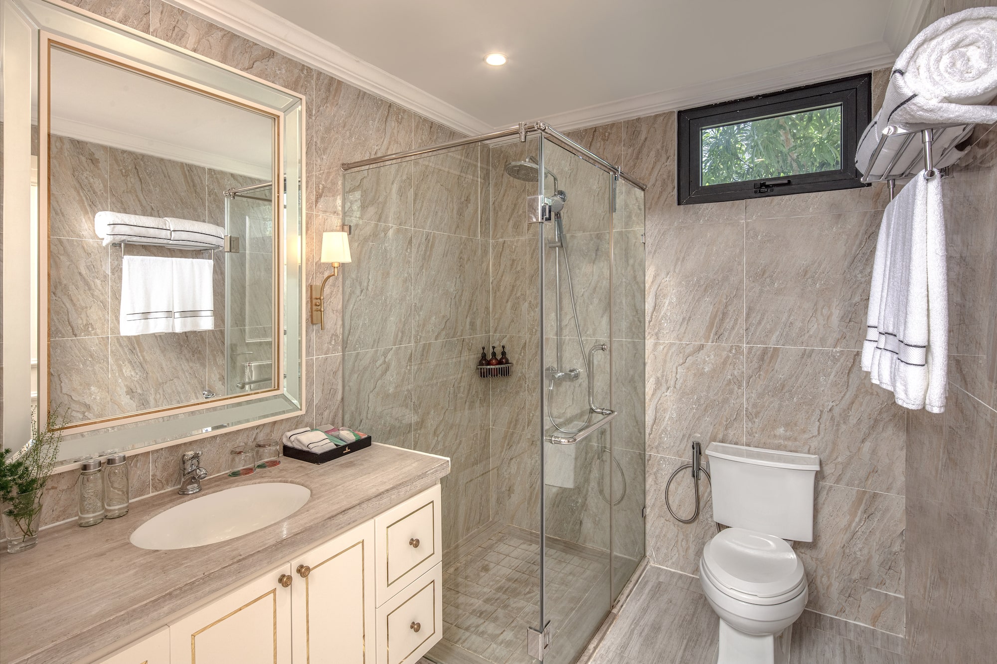 a bathroom with a glass shower and sink