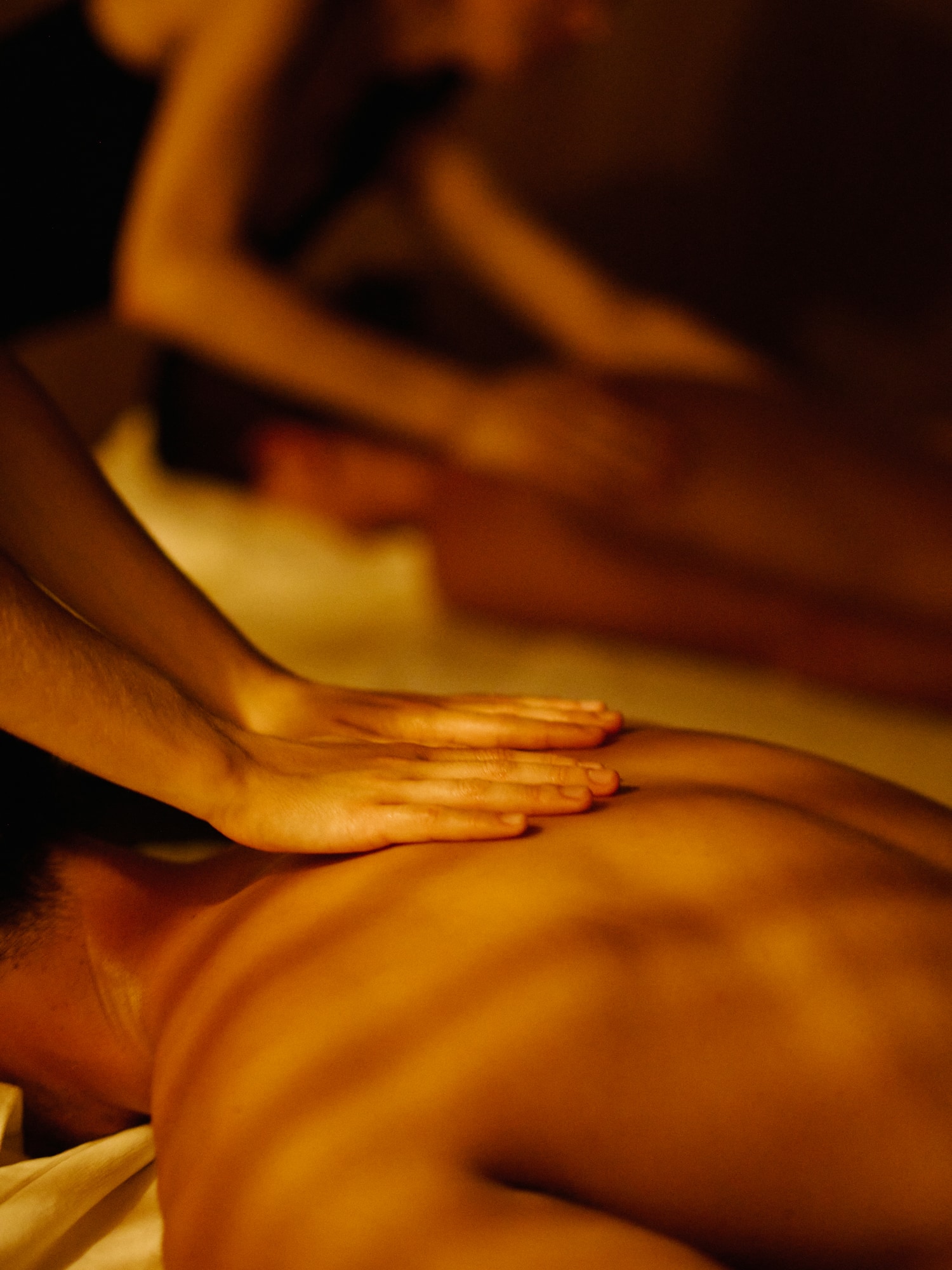 a person's hands on a man's back