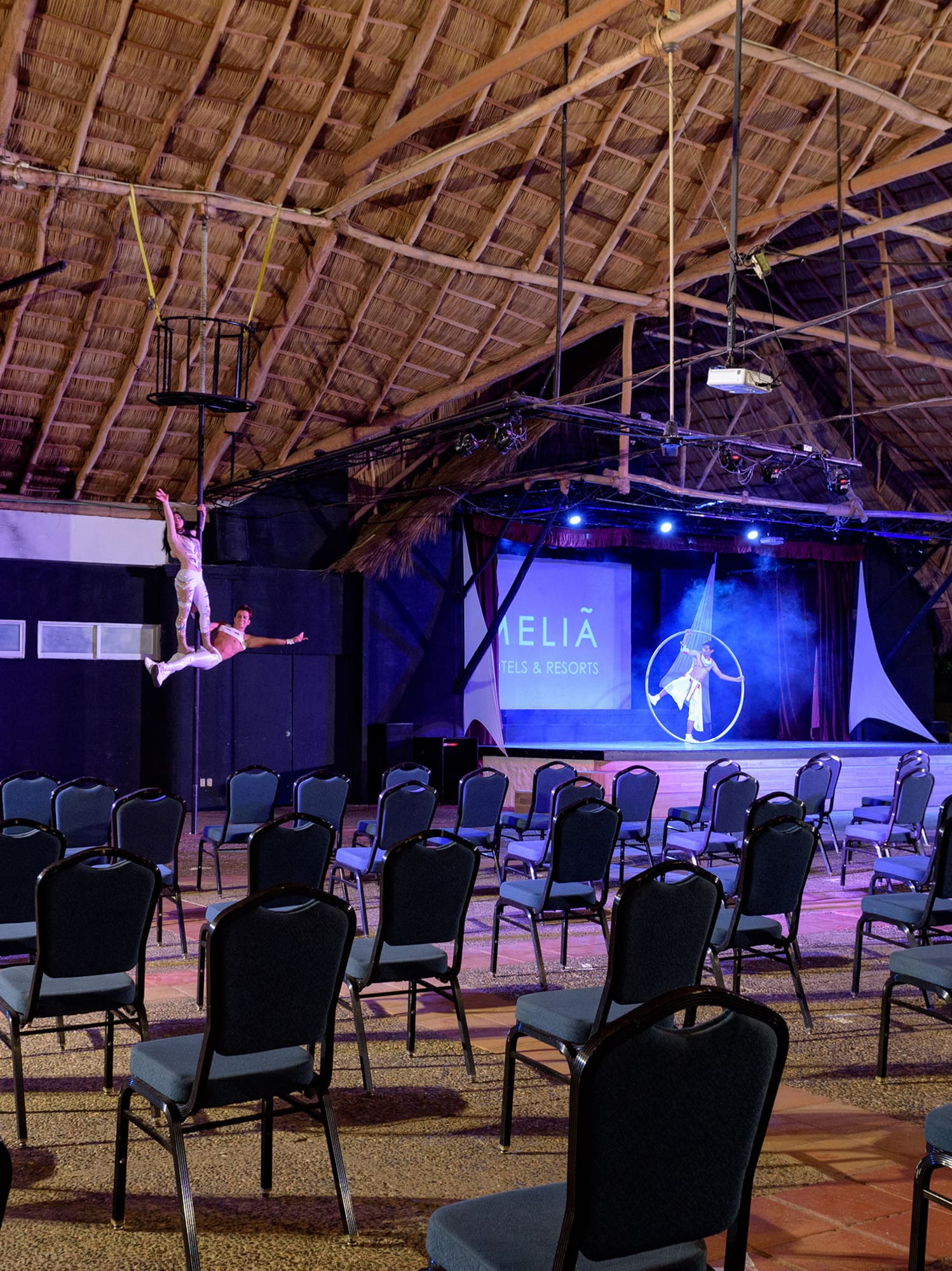 a group of chairs in a room with a man on the back
