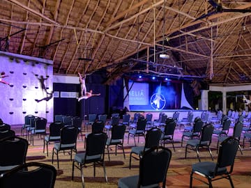 a group of chairs in a room with a man on the back