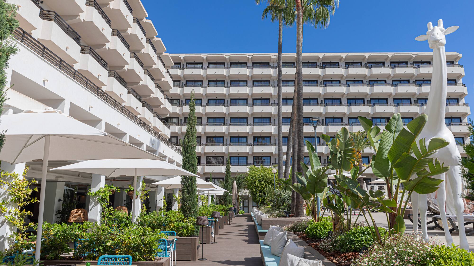 a building with many windows and plants