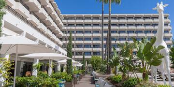 a building with many windows and plants