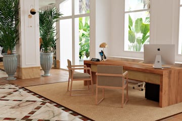a room with a desk and chairs