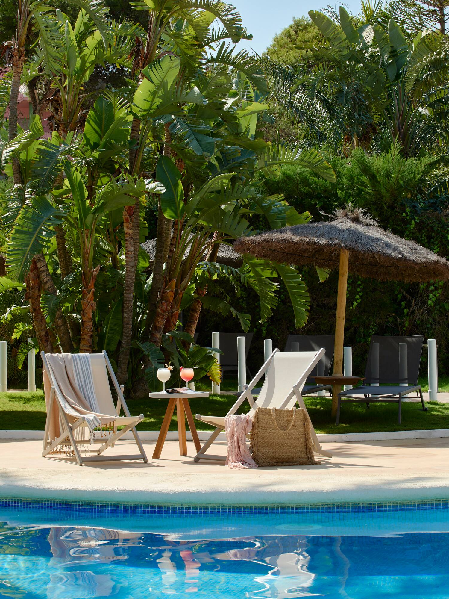 chairs and a table by a pool