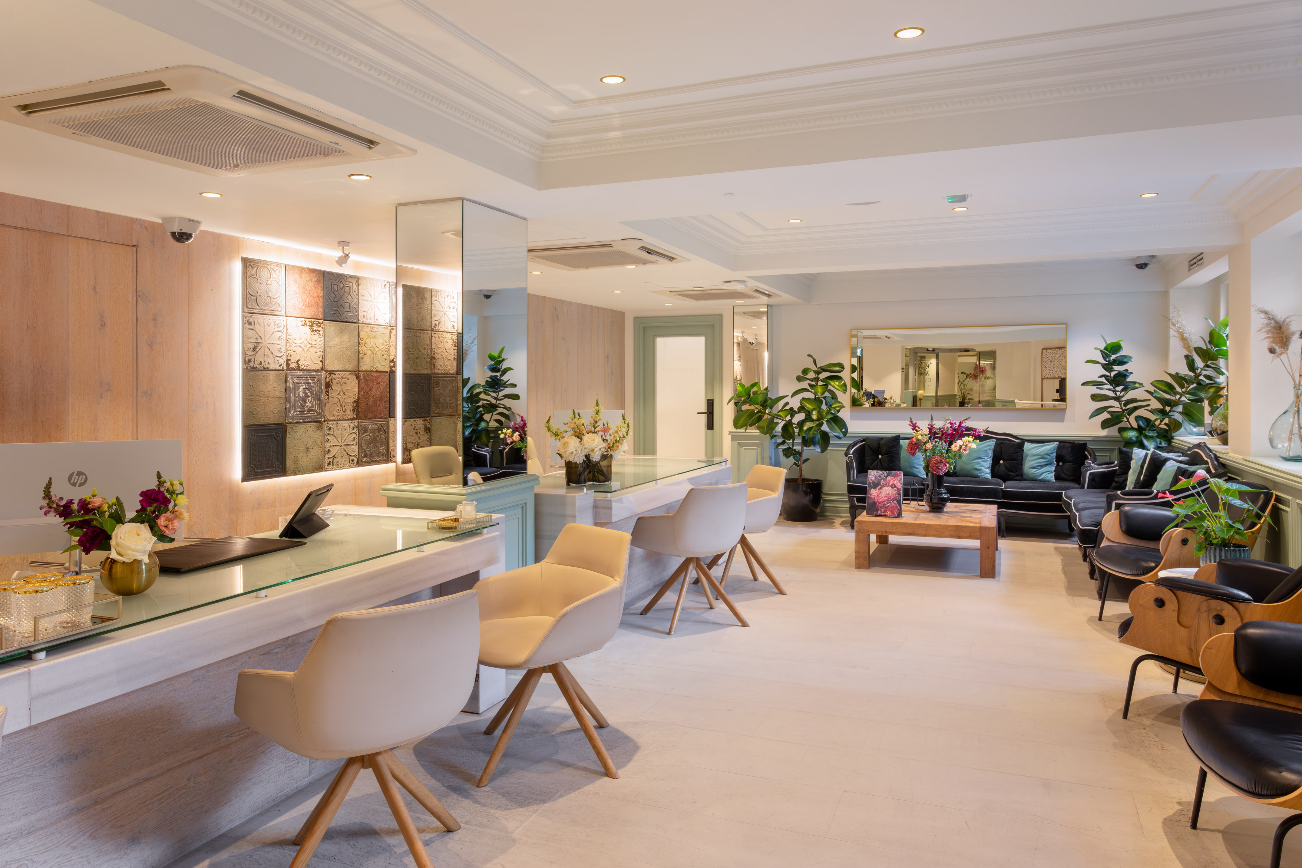 a room with a couch and chairs