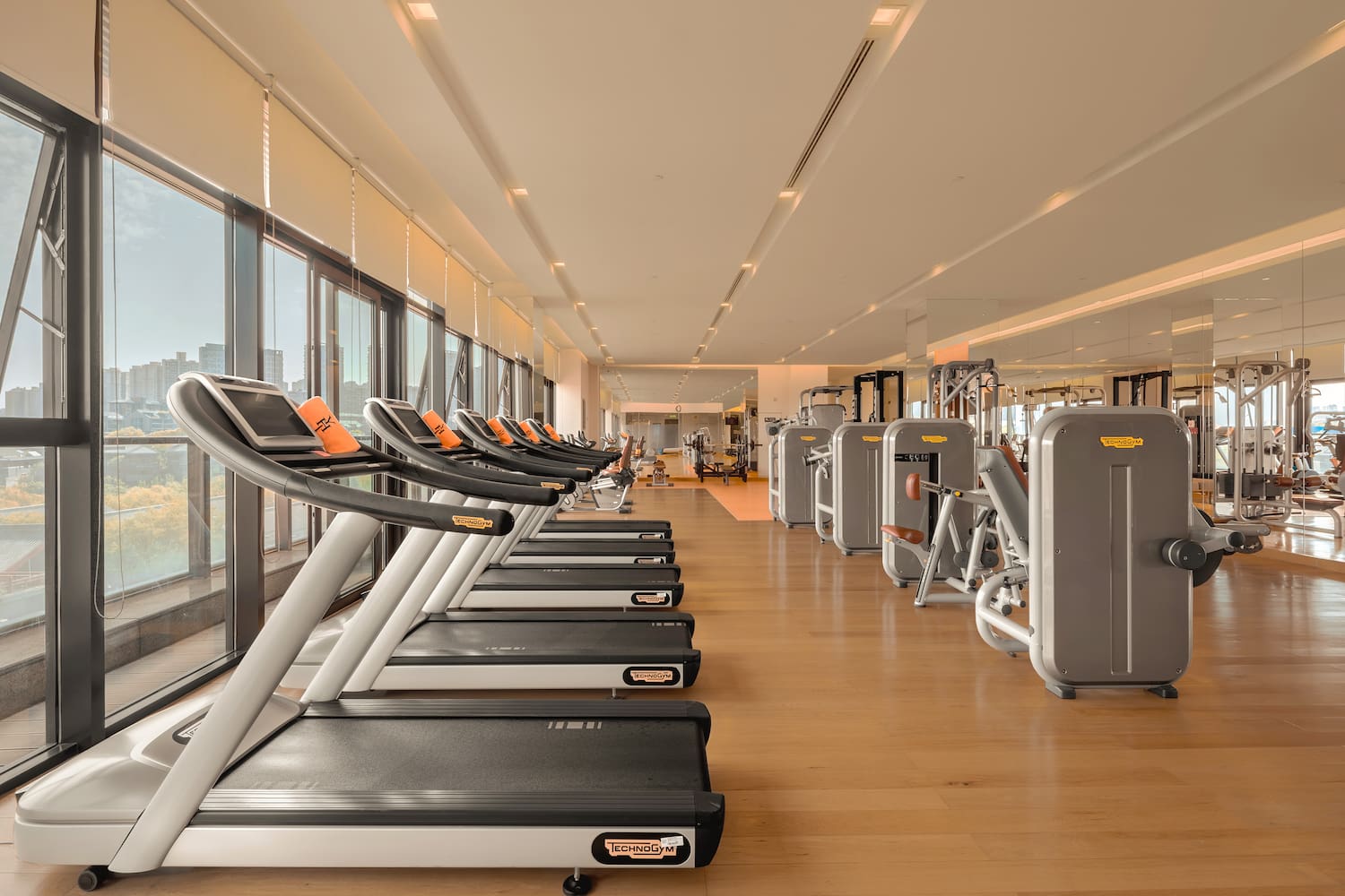 a large room with treadmills and exercise equipment