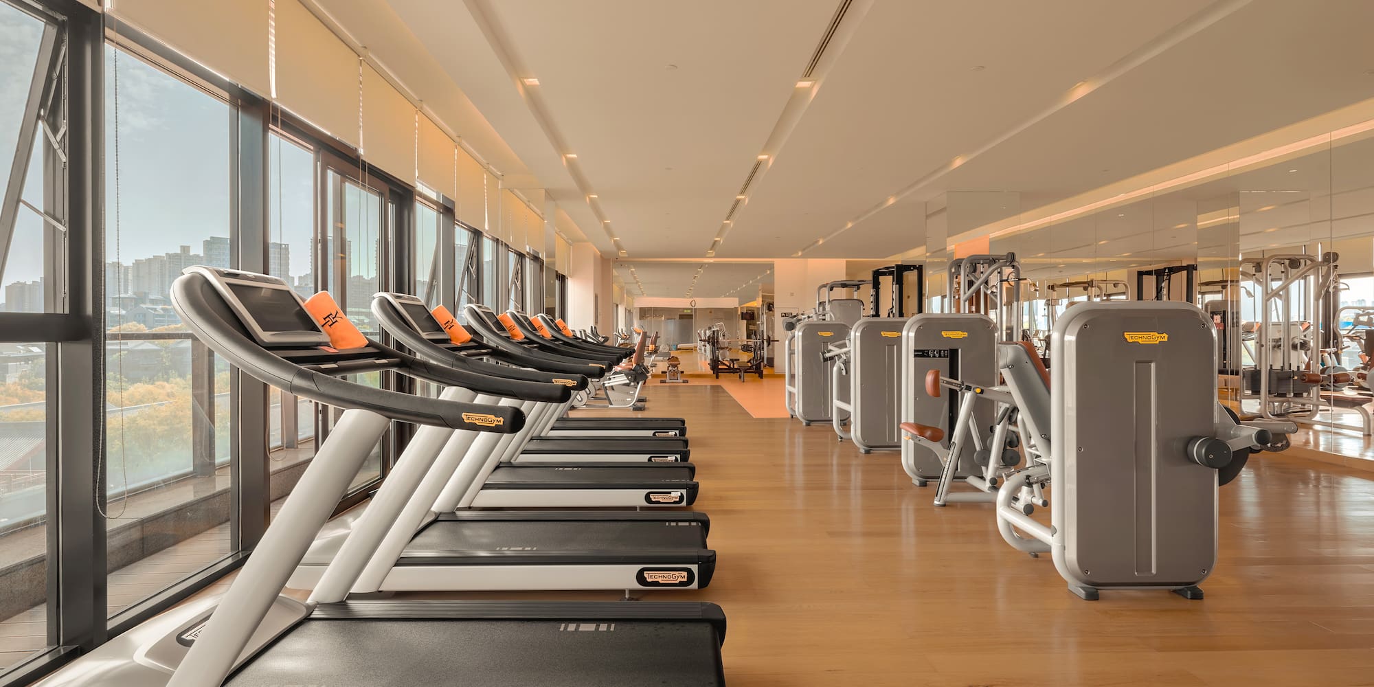 a large room with treadmills and exercise equipment