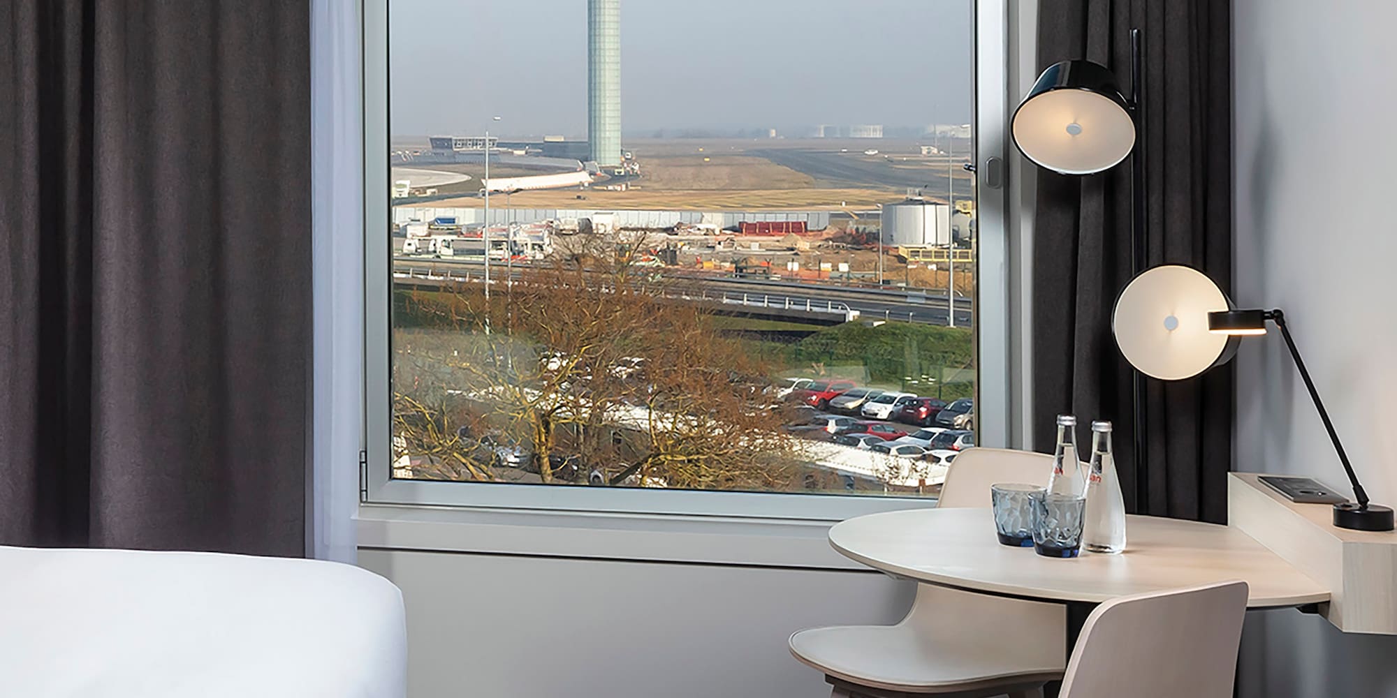 a room with a window and a table and chairs