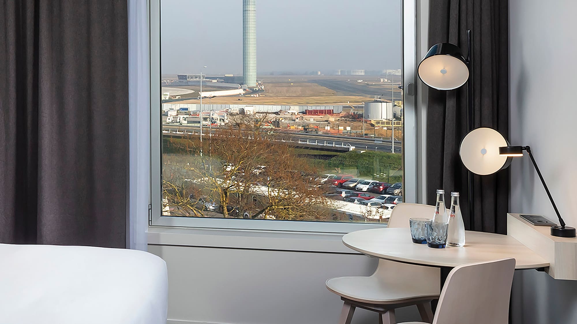 a room with a window and a table and chairs