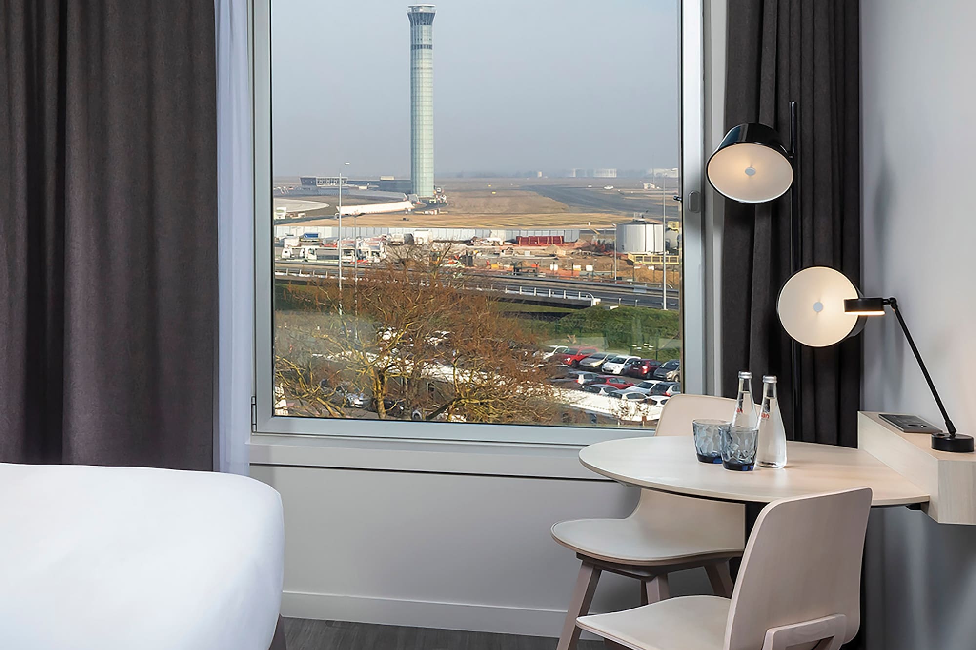 a room with a window and a table and chairs