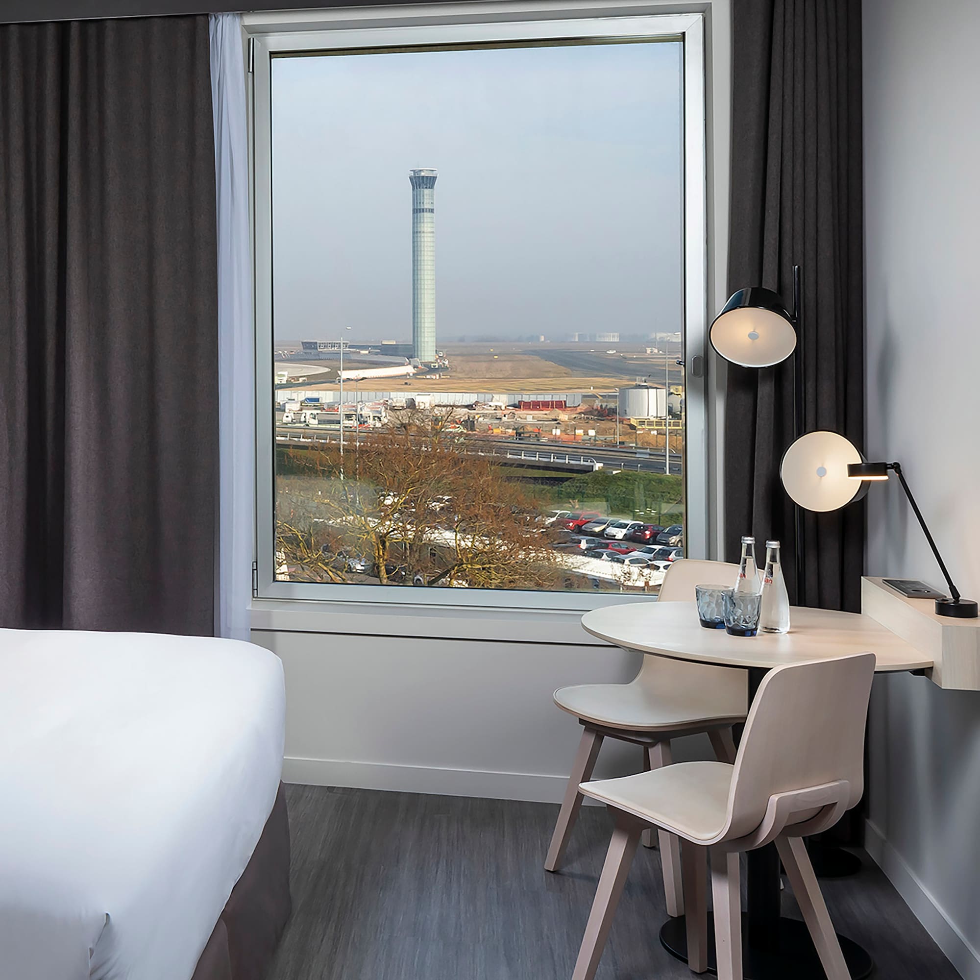 a room with a window and a table and chairs