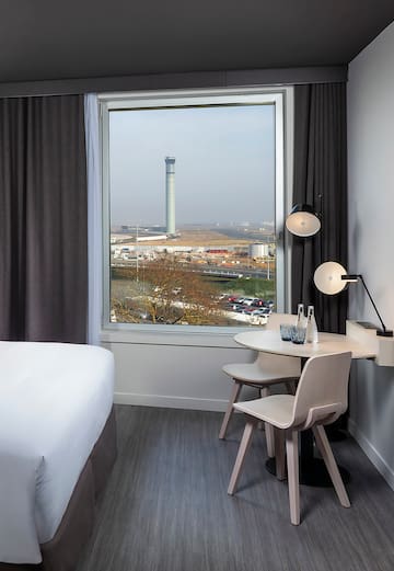 a room with a window and a table and chairs