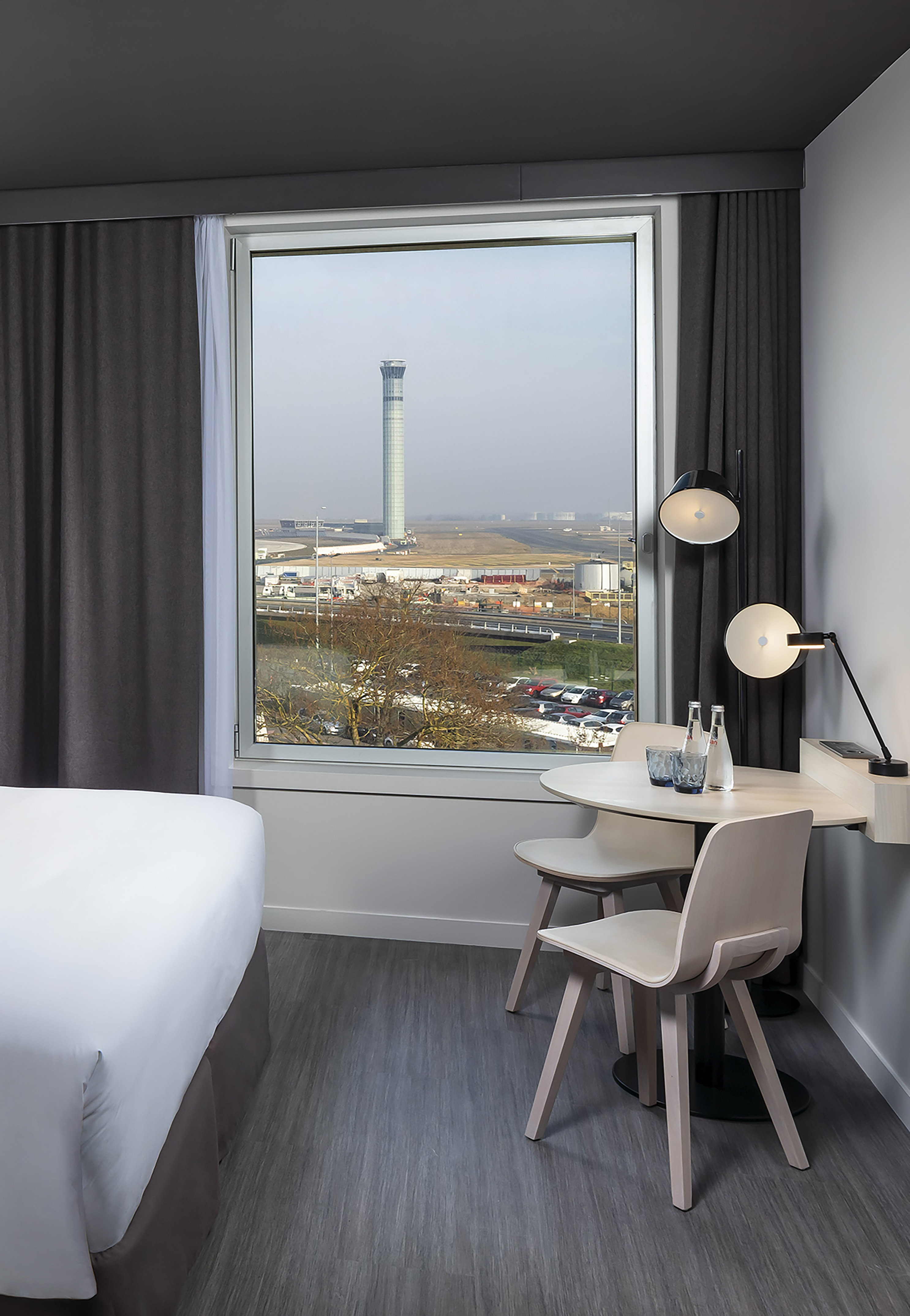 Airport view hotel room, featuring control tower and runway.