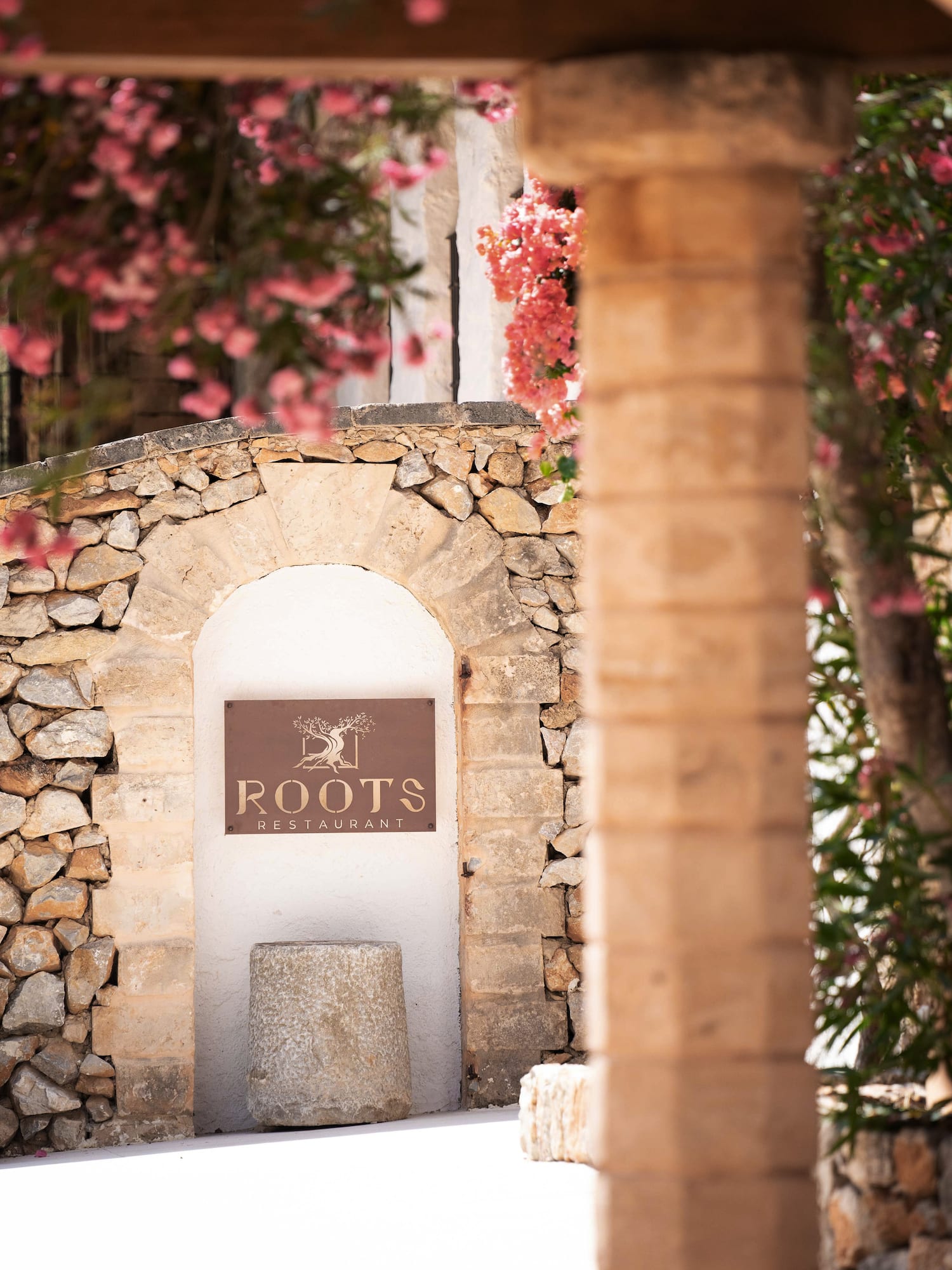a sign on a stone wall