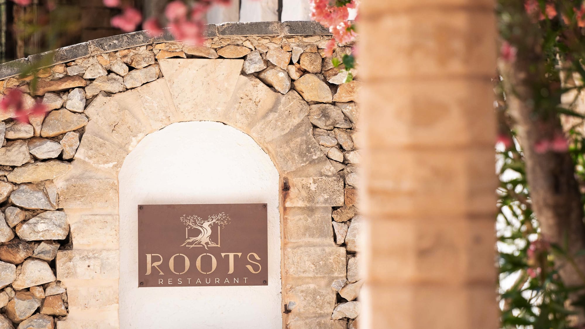 a sign on a stone wall