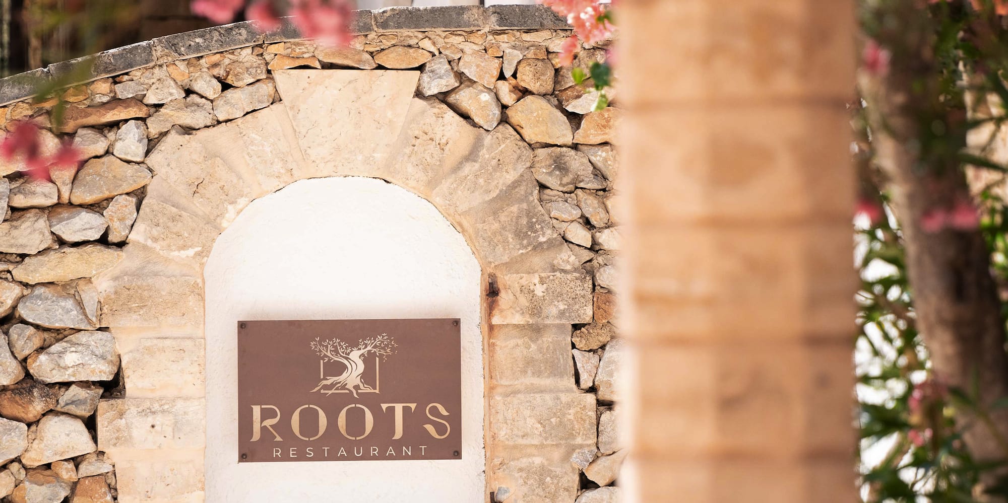 a sign on a stone wall