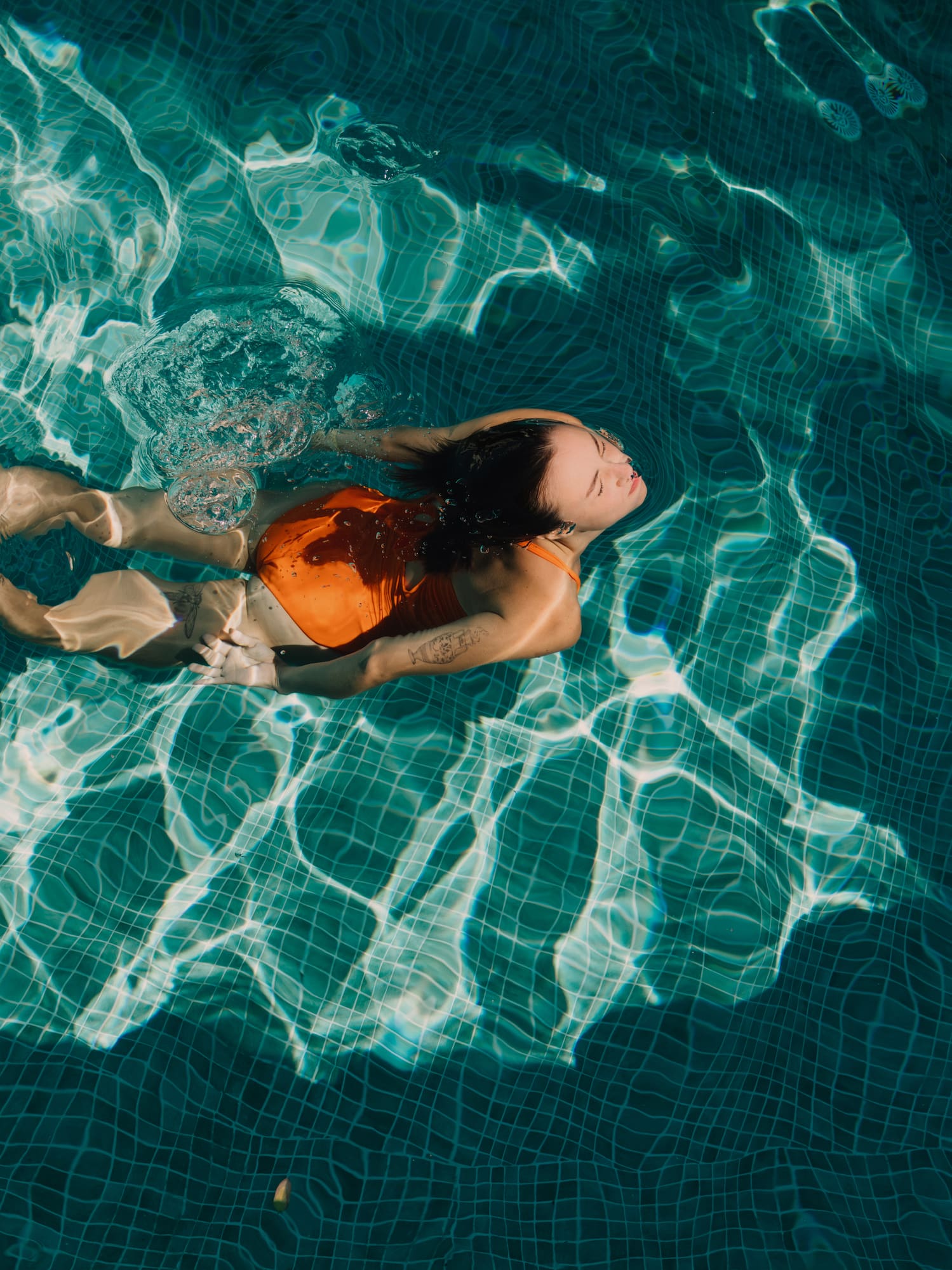 a woman in a swimsuit in a pool.