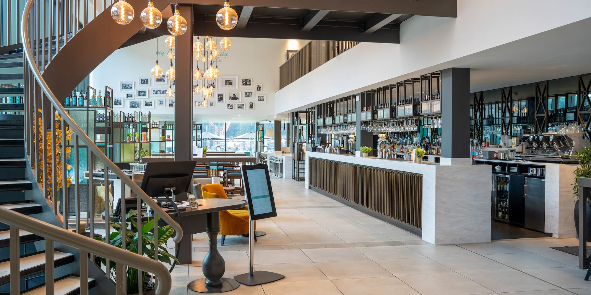 a large room with a bar and a staircase