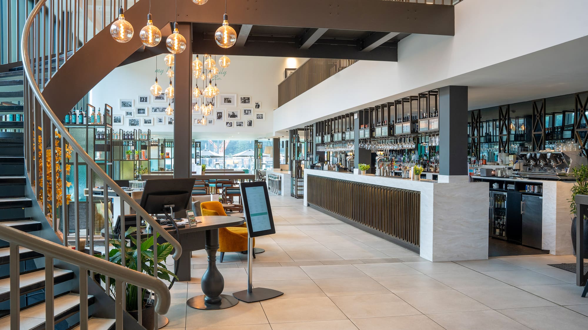 a large room with a bar and a staircase