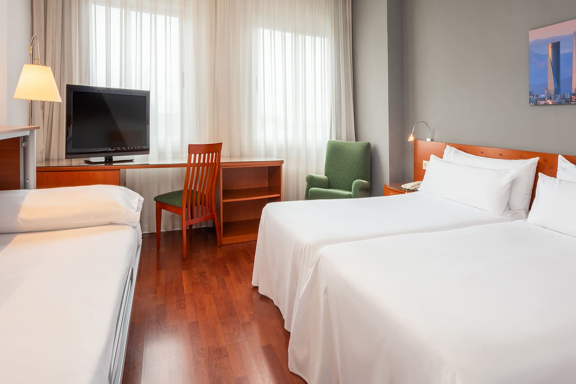 a room with two beds and a desk