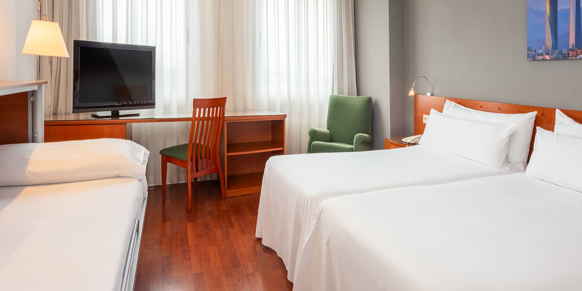 a room with two beds and a desk