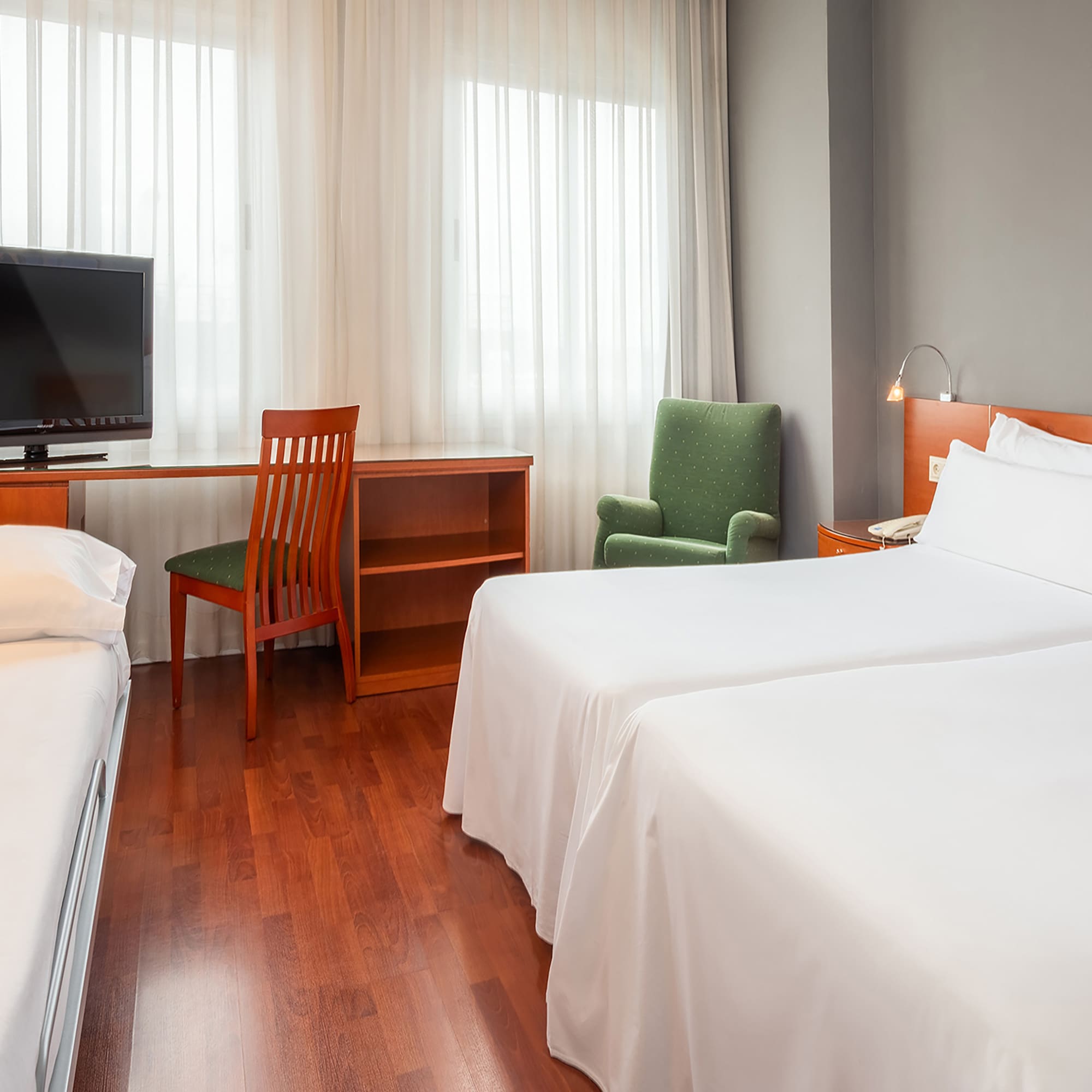 a room with two beds and a desk