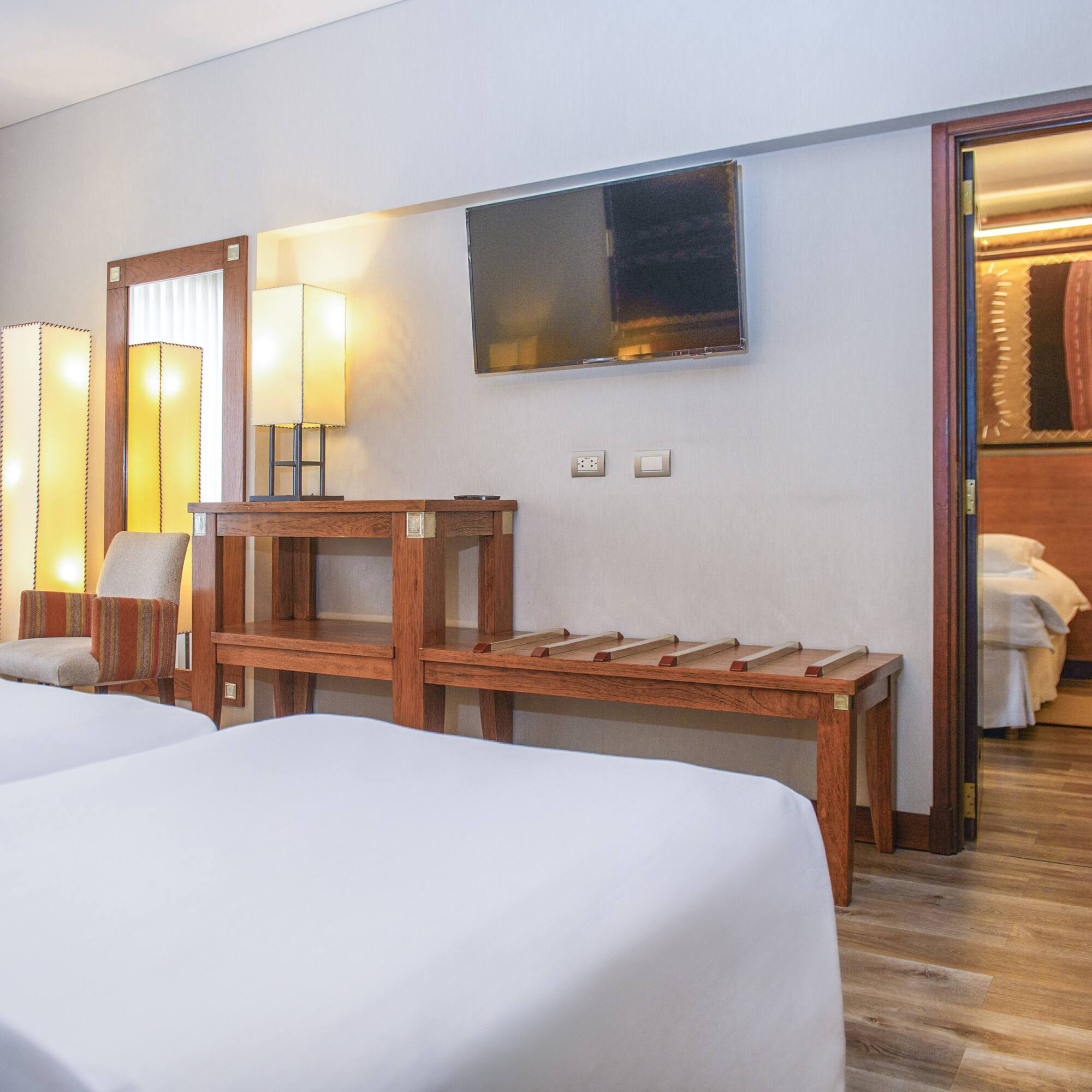 a room with two beds and a television