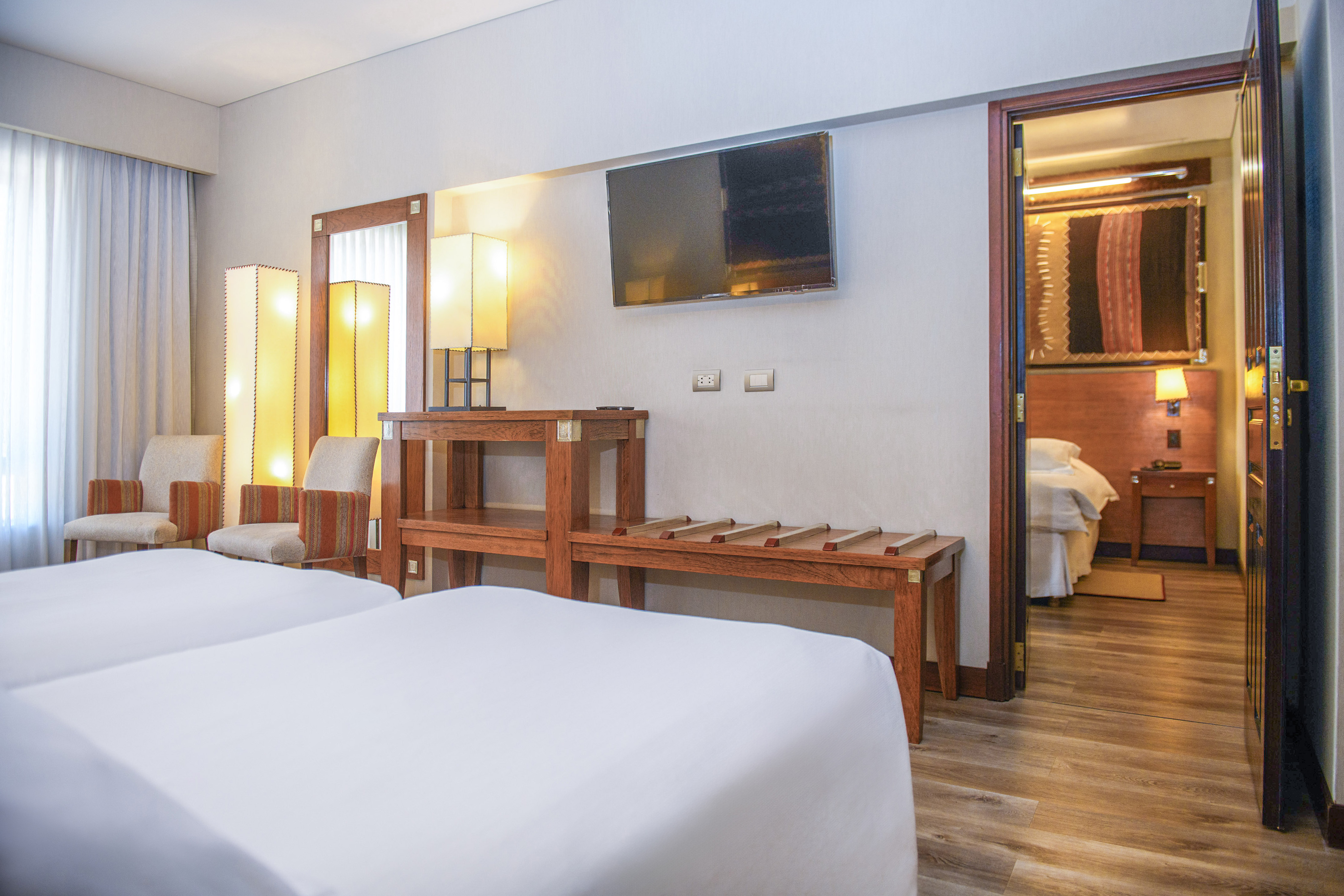 a room with two beds and a television