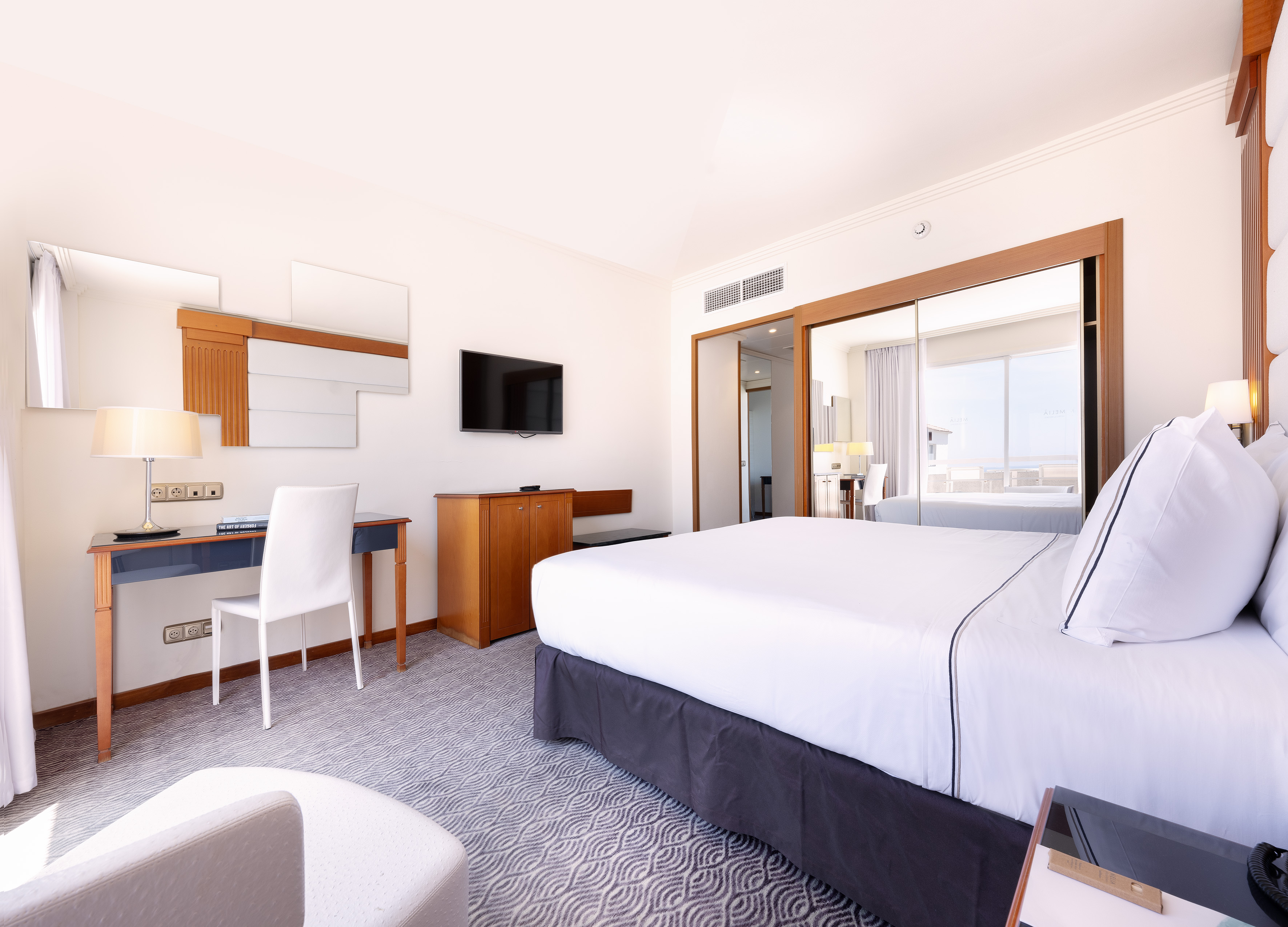 a room with a bed and a desk