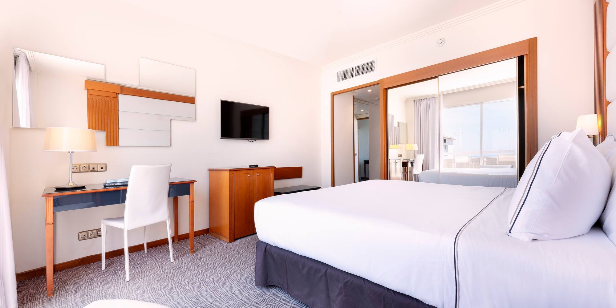 a room with a bed and a desk