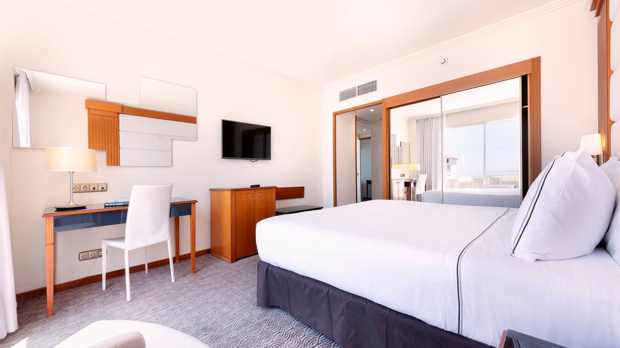 a room with a bed and a desk