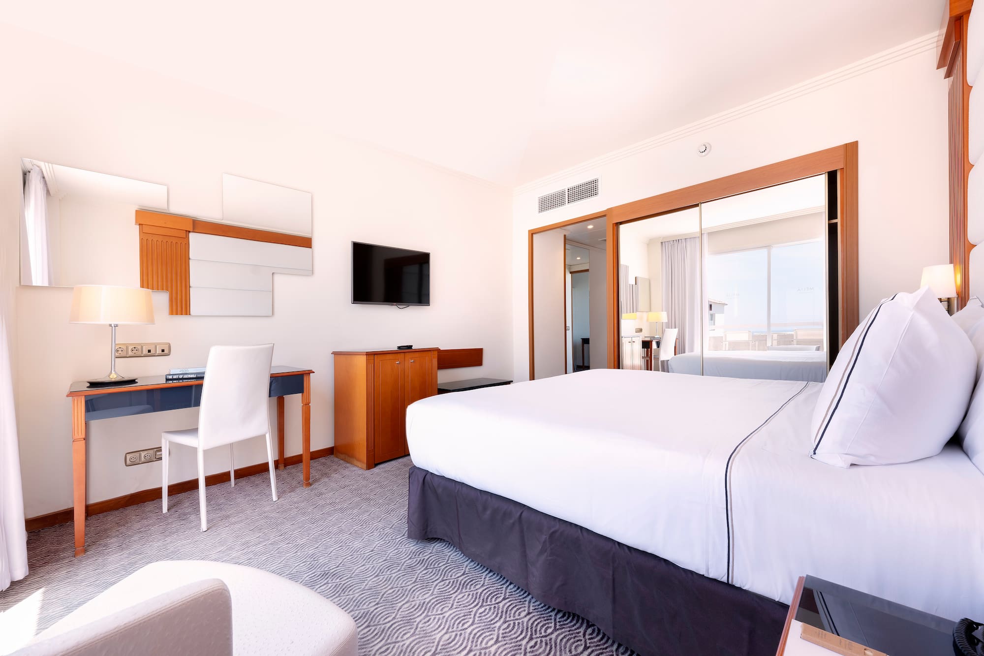 a room with a bed and a desk