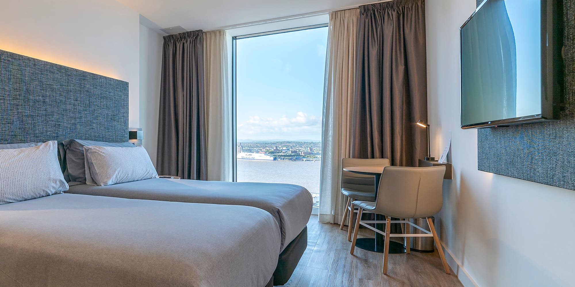 a room with two beds and a television