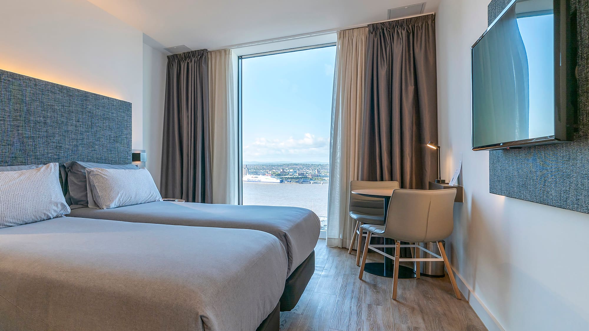 a room with two beds and a television