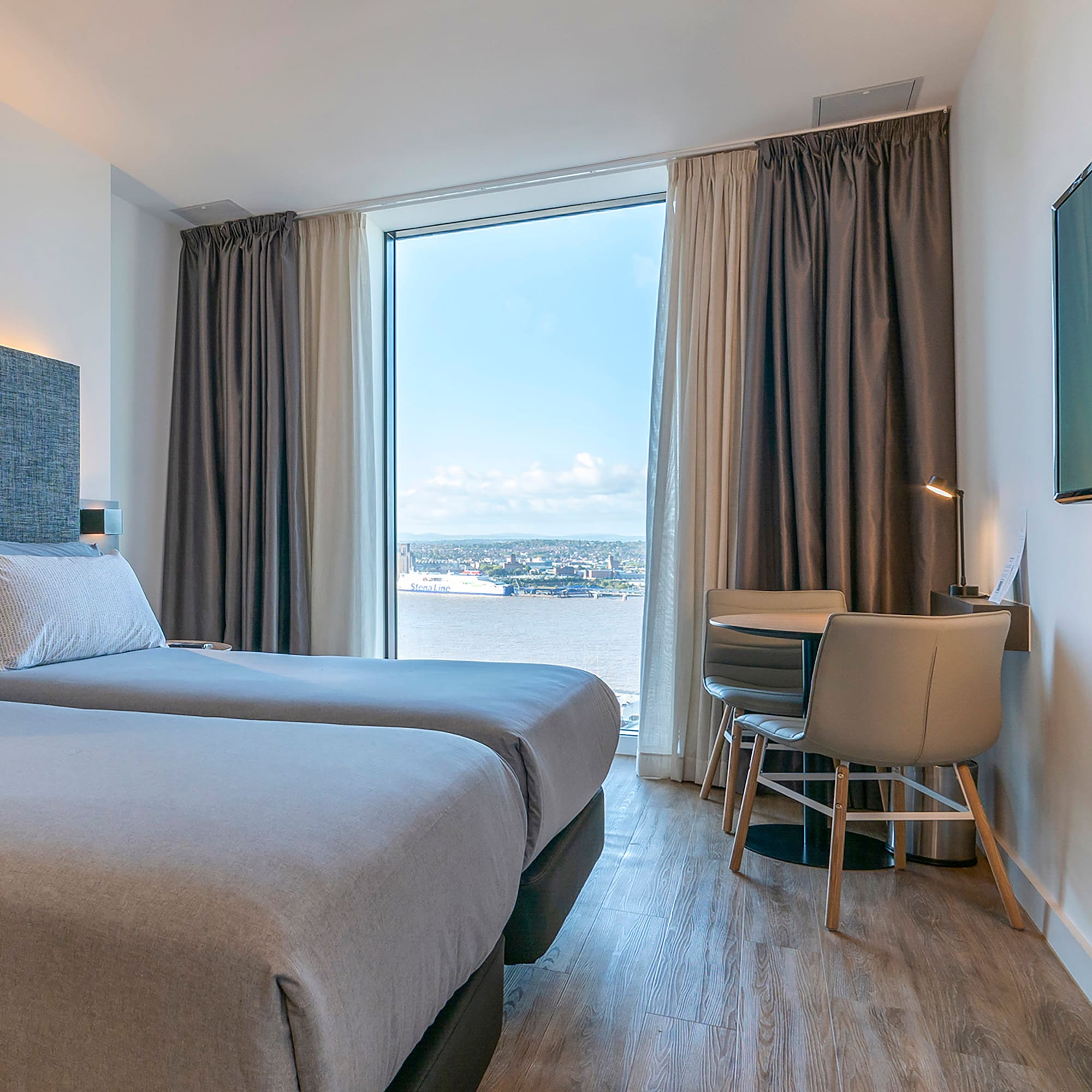 a room with two beds and a television