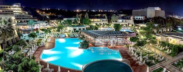 a pool with a gazebo and a building with trees and buildings