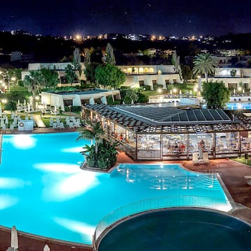 a pool with a gazebo and a building with trees and buildings