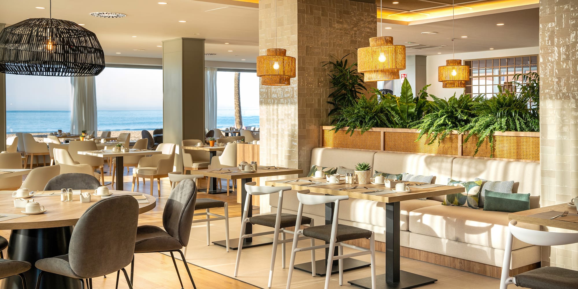 a room with a couch and tables and chairs