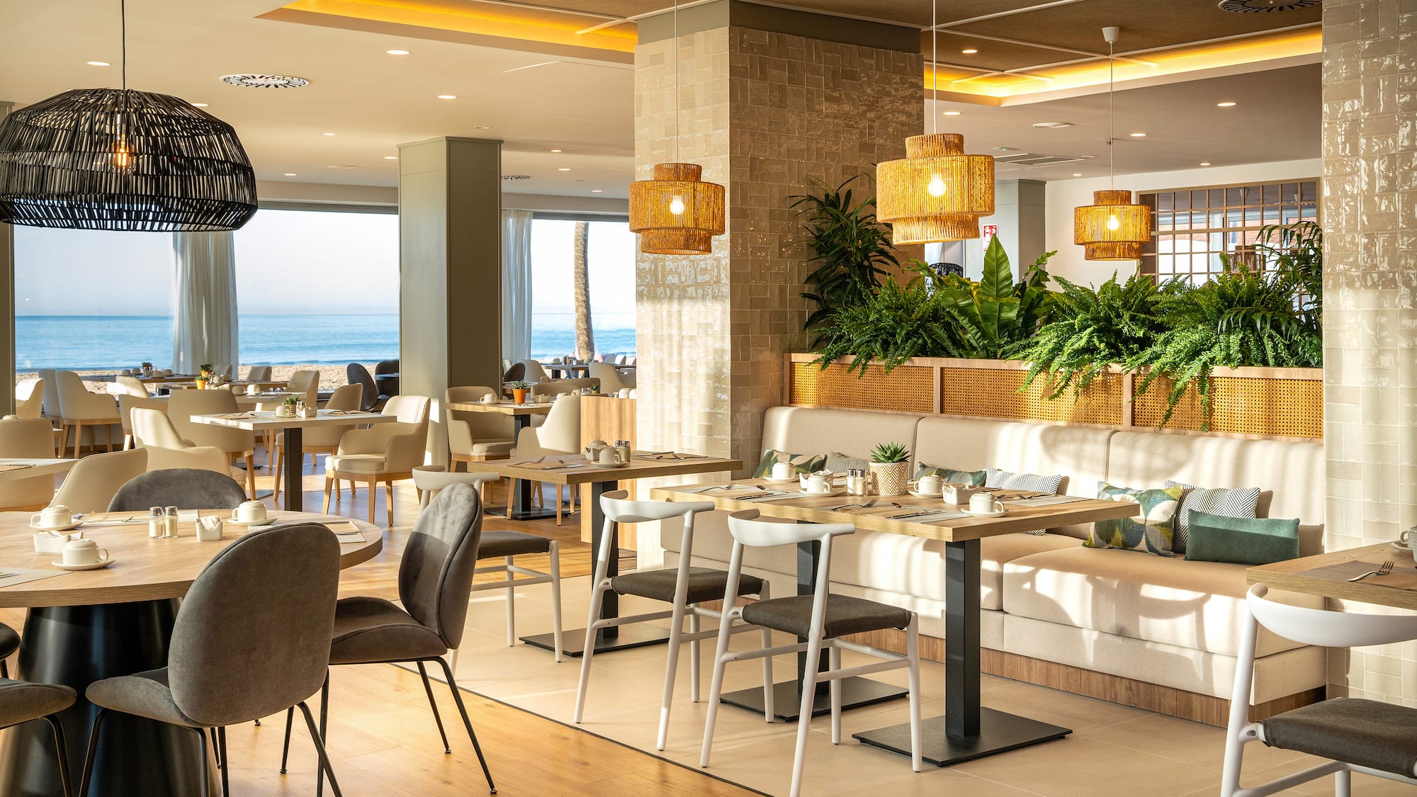 a room with a couch and tables and chairs