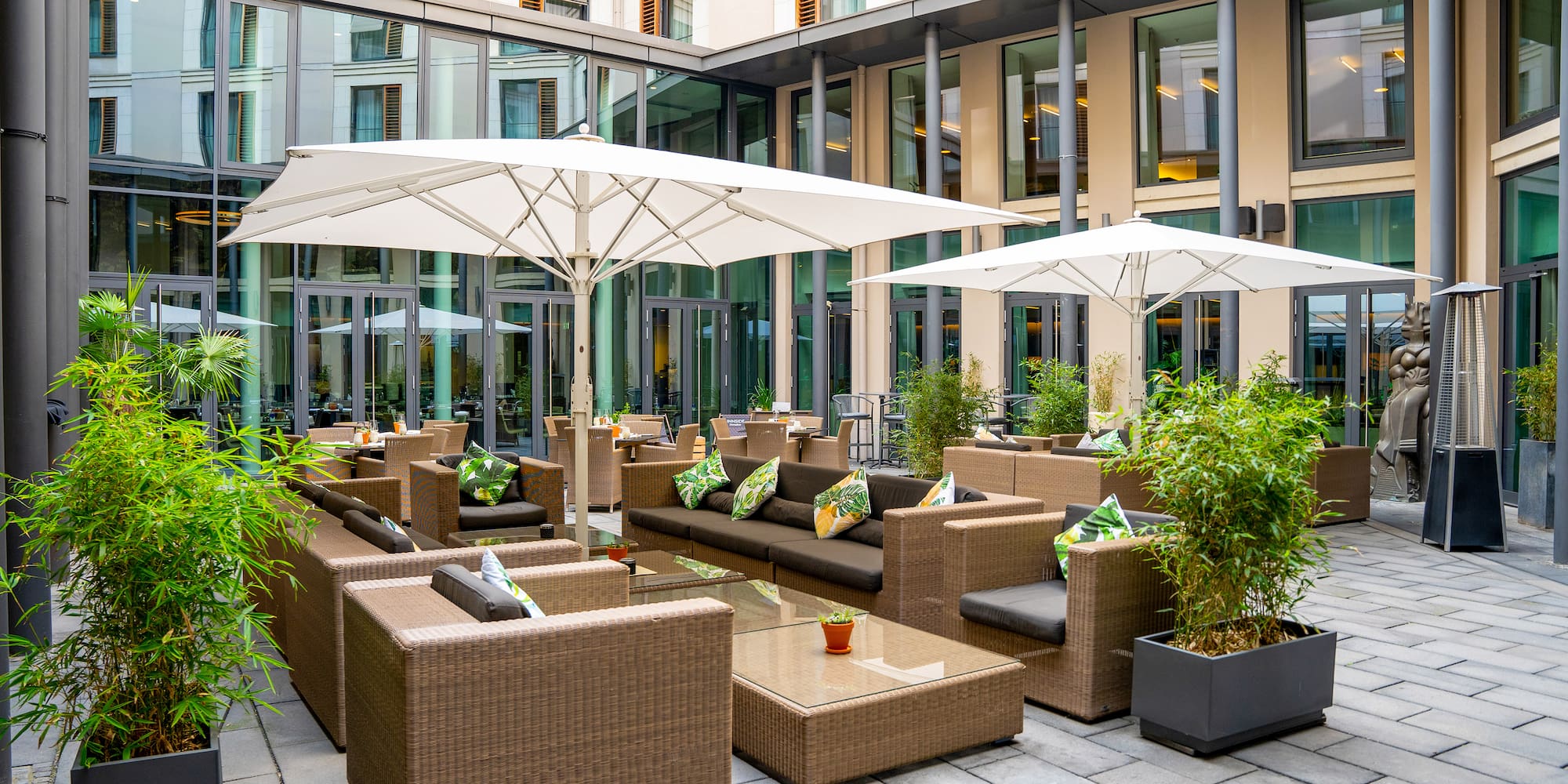 a patio area with chairs and umbrellas
